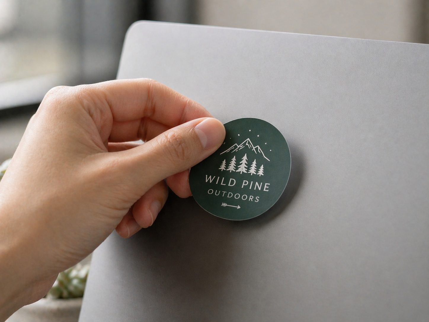 Die-cut custom sticker being applied to a surface